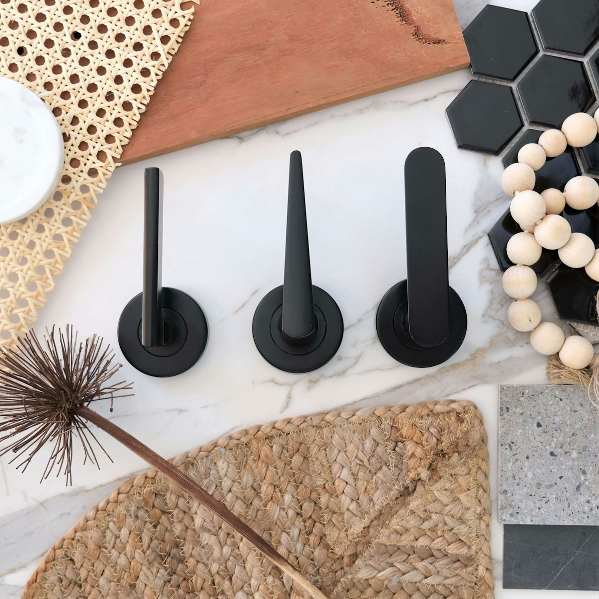 a table topped with black knobs and a straw hat