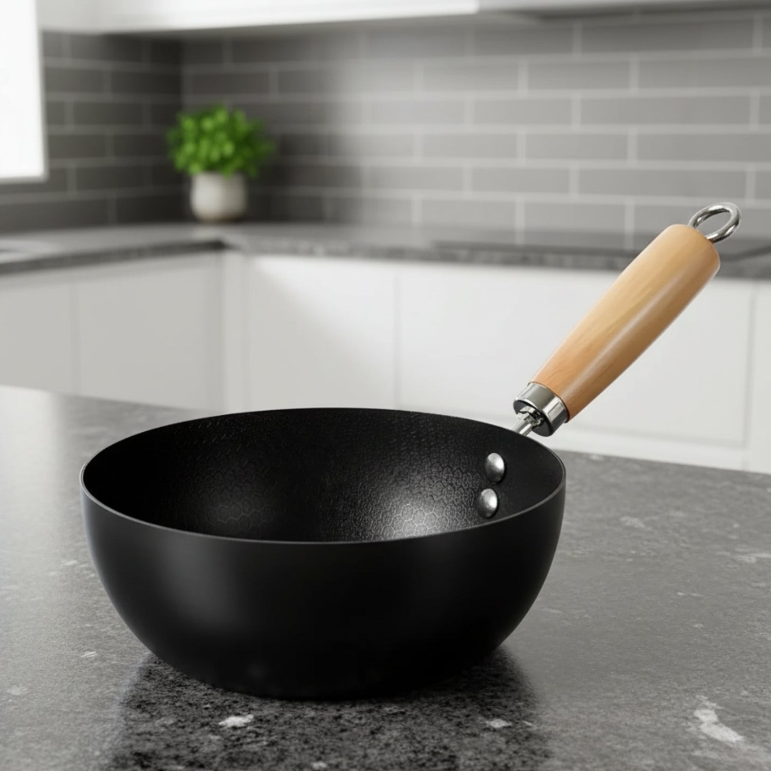 Black wok with a wooden handle on a kitchen counter
