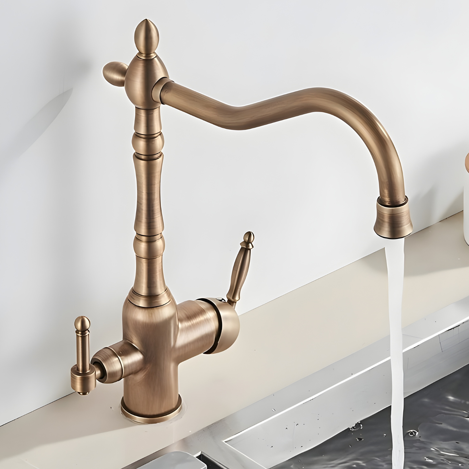 Bronze kitchen faucet with water flowing into a sink against a white background