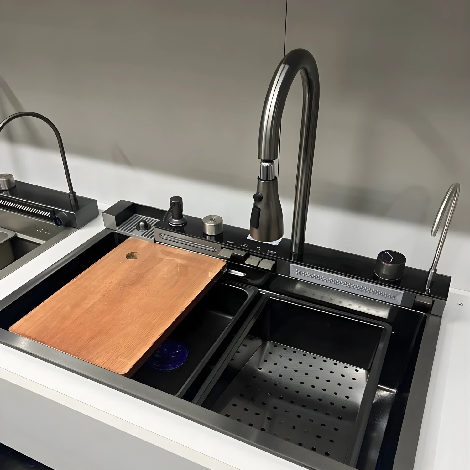 Modern kitchen sink with black faucet and wooden cutting board