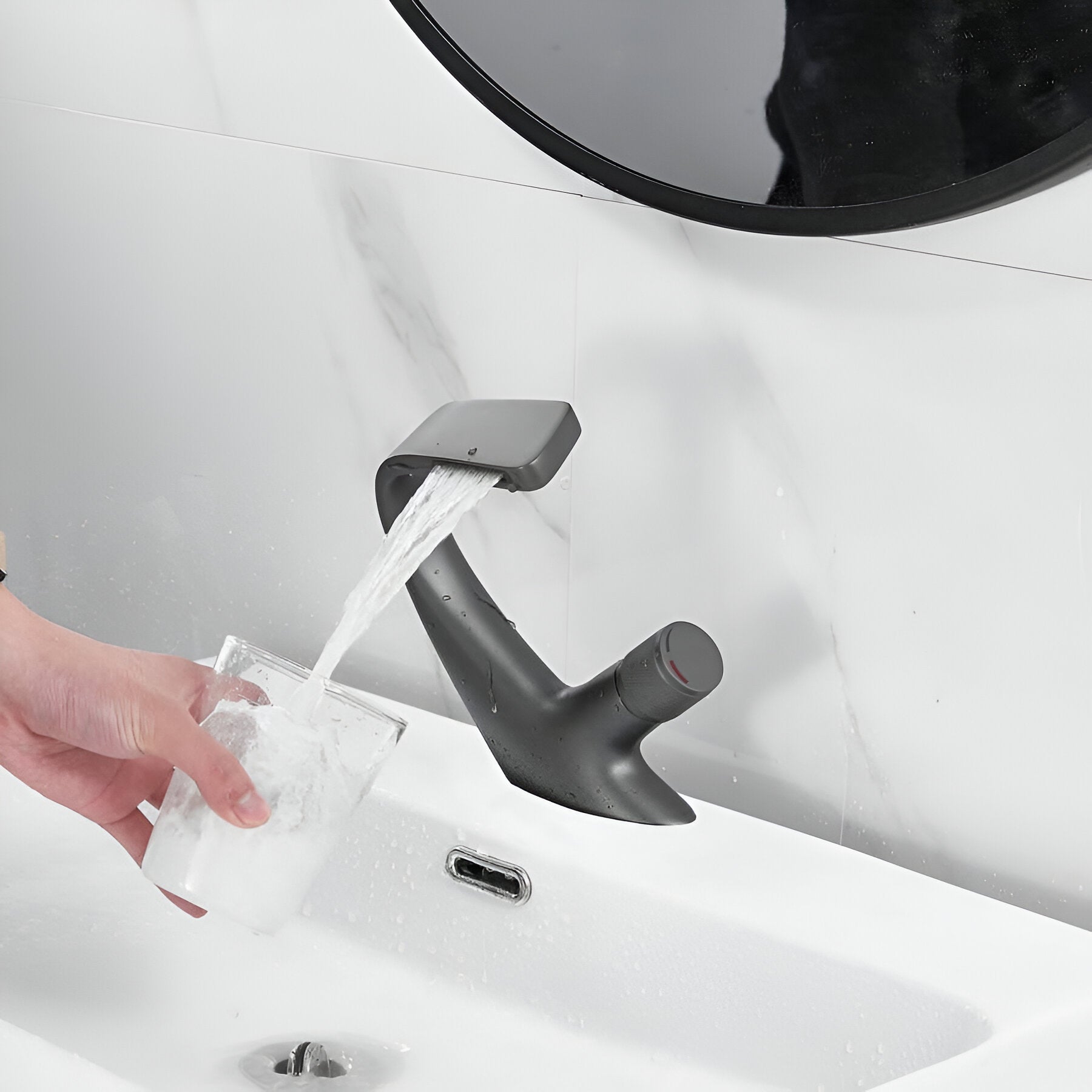 Filling a glass of water with a gray elegant faucet