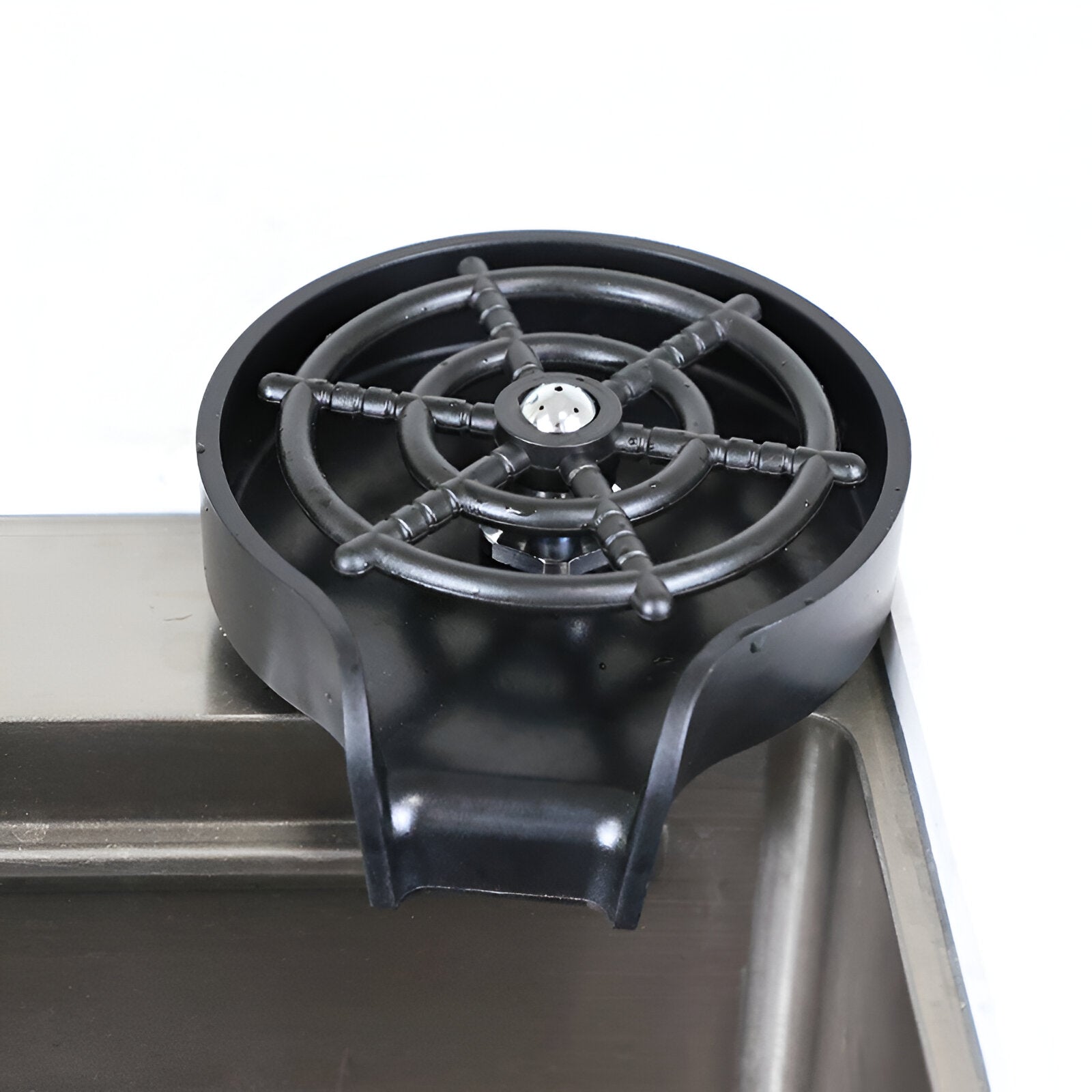 Black glass rinser set on a sink