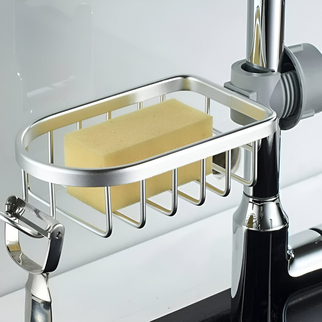 Faucet storage rack attached to a faucet holding a sponge